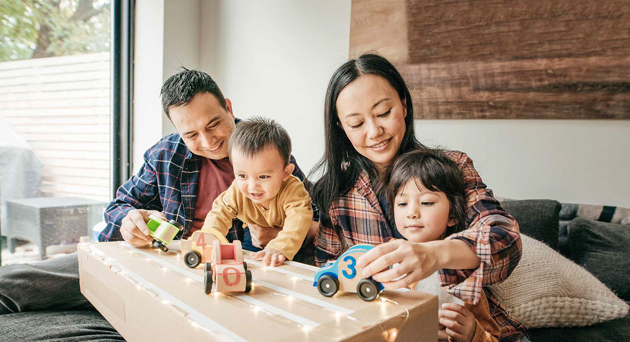 family playing with toy cars